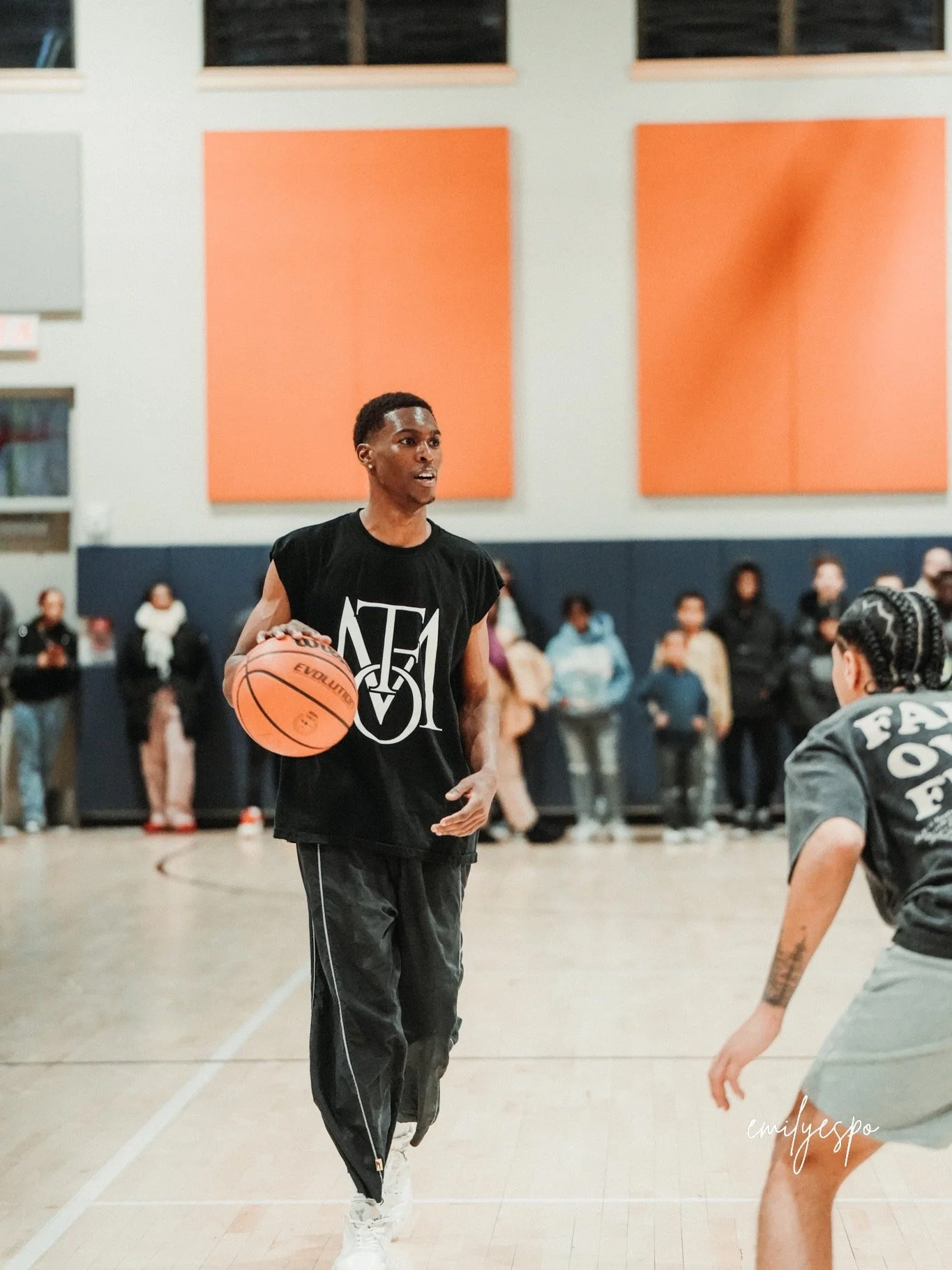 Jordan Lewis, known as Jlewww, holding a basketball on an indoor court