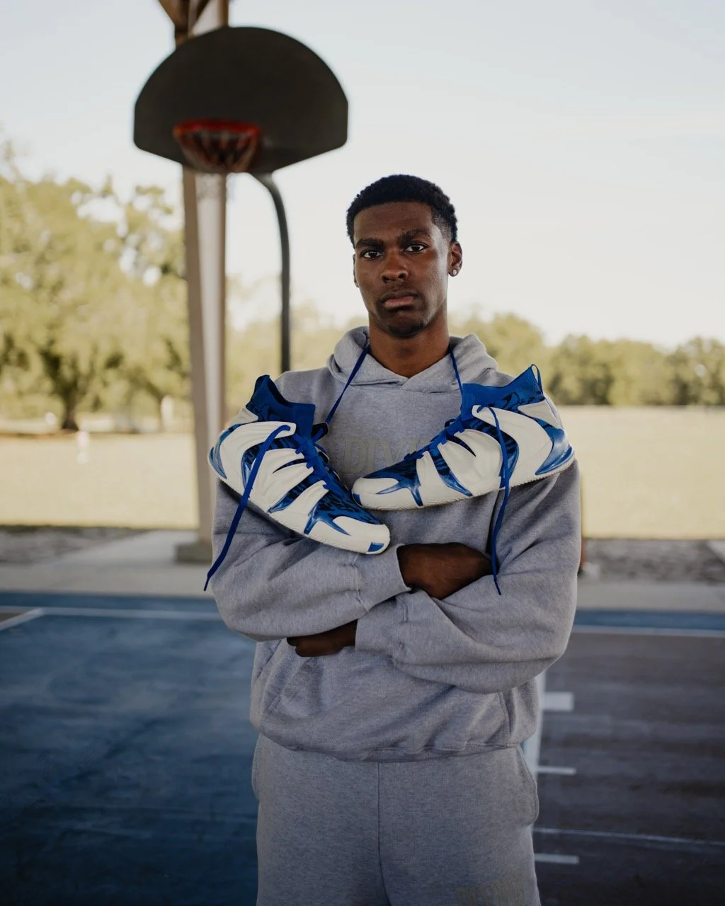 Jordan Lewis on an outdoor basketball court in the JLEW shoe