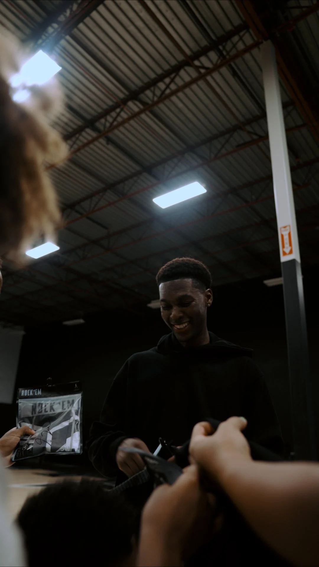 Jordan Lewis signing items at a public event